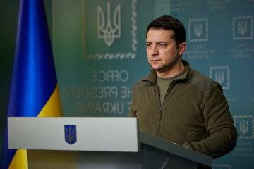 Ukrainian President Volodymyr Zelenskyy stands at a podium