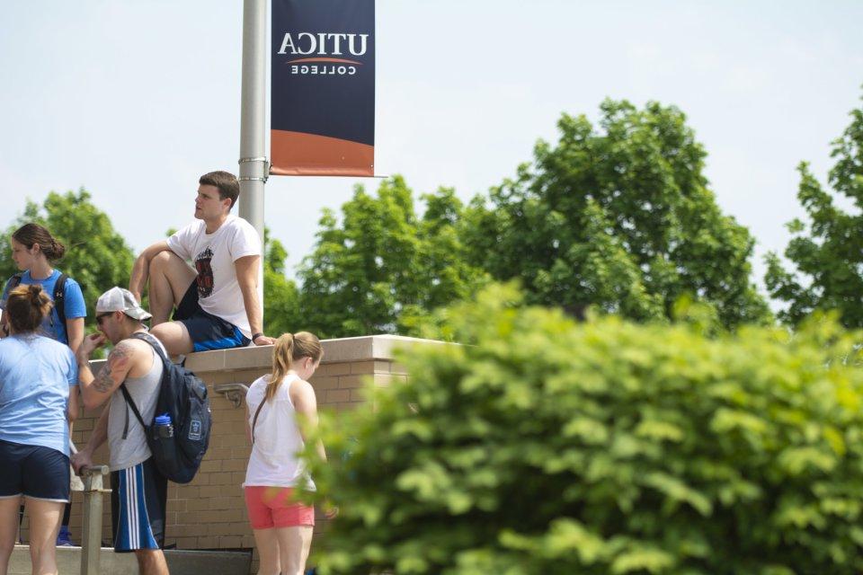 Campus Scenic - Students sit on wall